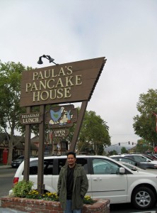 In front of the restaurant sign